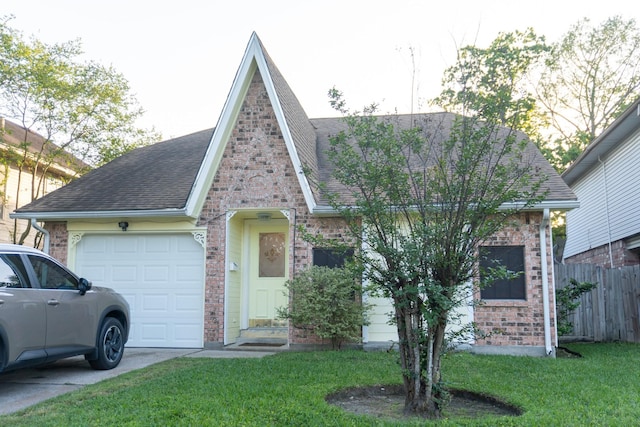1527 Carbonear Dr, Channelview, TX 77530 - tudor home with a front lawn, a garage, a shingled roof, and brick siding