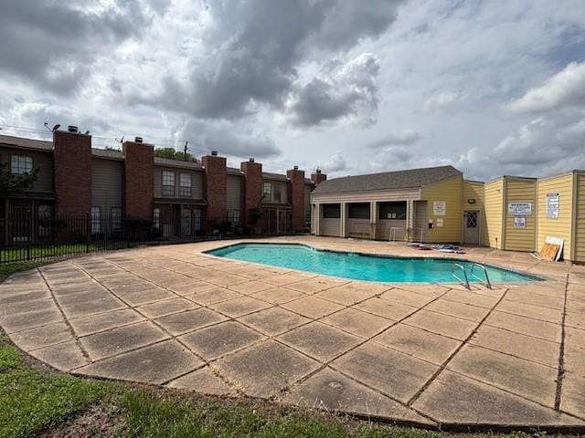 pool featuring a patio and fence
