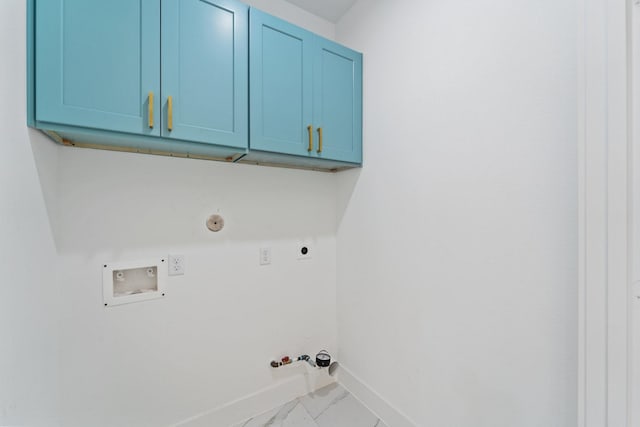 laundry area featuring cabinet space, hookup for an electric dryer, gas dryer hookup, washer hookup, and baseboards