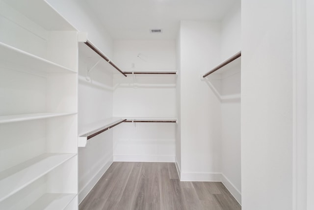 spacious closet featuring visible vents and light wood-style floors