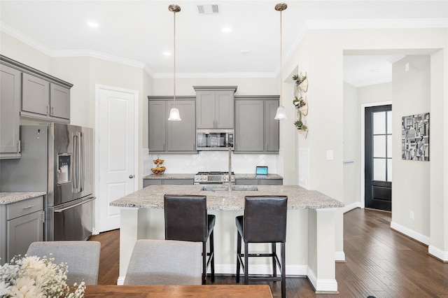kitchen with appliances with stainless steel finishes, visible vents, backsplash, and gray cabinets