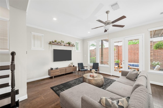 living area with ornamental molding, visible vents, and dark wood finished floors