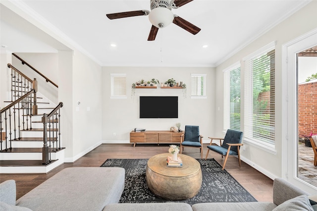 living room with ceiling fan, baseboards, wood finished floors, and plenty of natural light