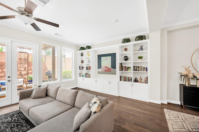 living area with crown molding, visible vents, ceiling fan, and wood finished floors
