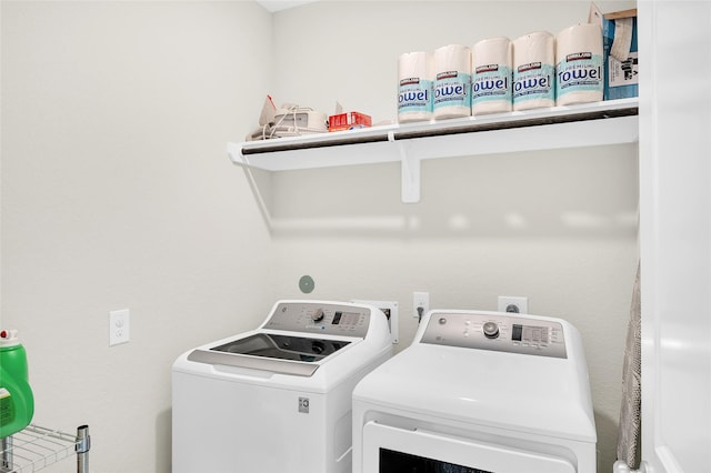 clothes washing area with separate washer and dryer and laundry area
