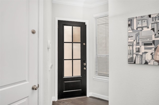 doorway featuring crown molding, dark wood-style floors, and baseboards