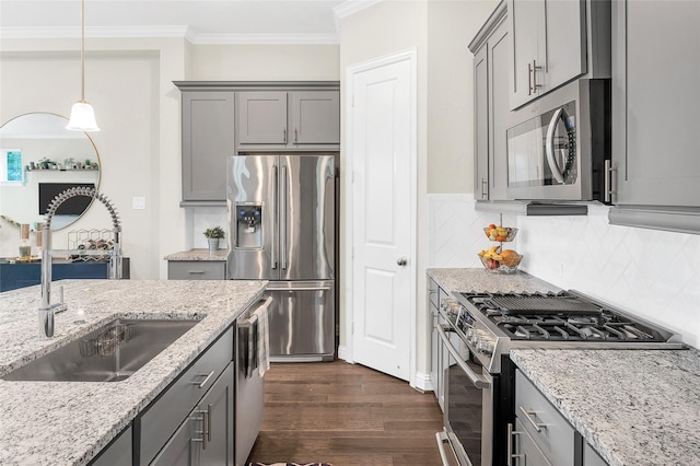 kitchen with gray cabinetry, a sink, and appliances with stainless steel finishes