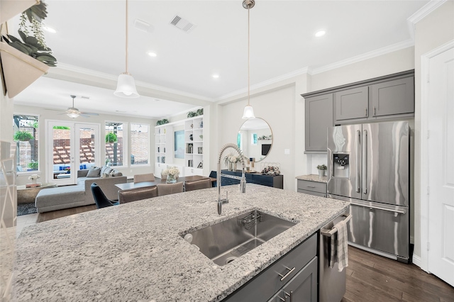 kitchen featuring a sink, ornamental molding, gray cabinets, and appliances with stainless steel finishes