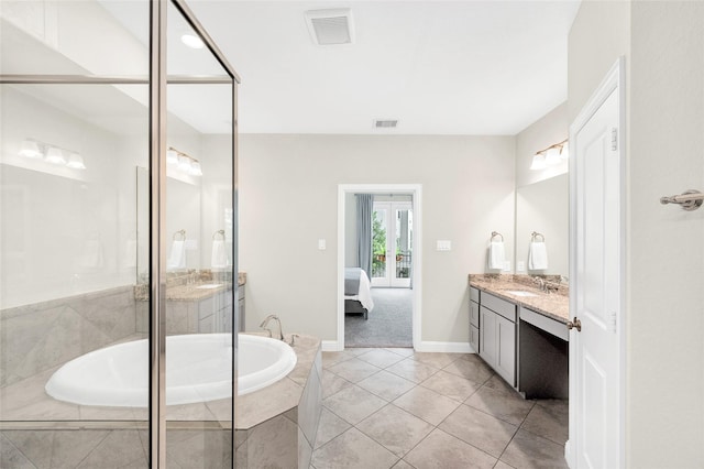 ensuite bathroom with connected bathroom, tile patterned floors, a bath, vanity, and visible vents