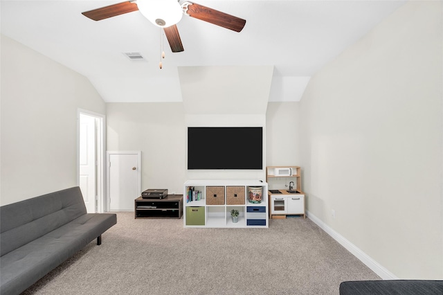 carpeted living area with visible vents, a ceiling fan, vaulted ceiling, and baseboards