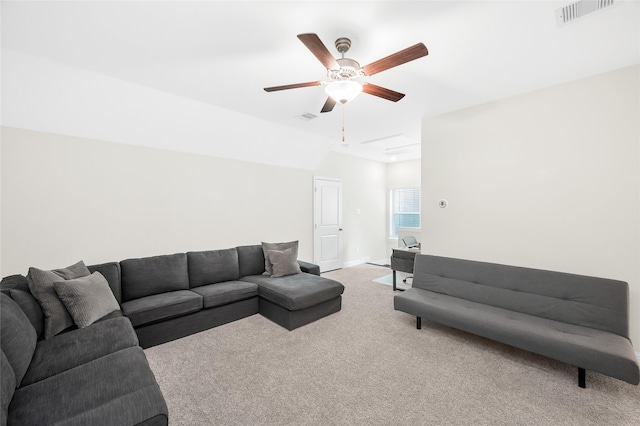 carpeted living area with a ceiling fan, visible vents, and baseboards