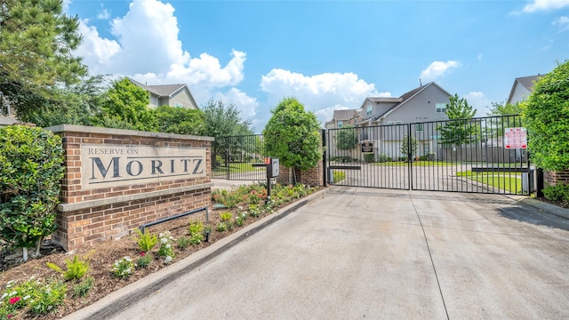 exterior space featuring a gated entry, curbs, and a gate