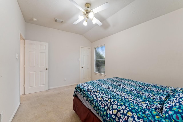 bedroom featuring light colored carpet, baseboards, visible vents, and vaulted ceiling