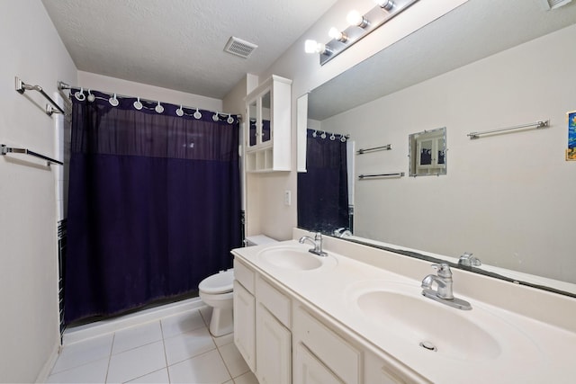 bathroom featuring a sink, tile patterned floors, toilet, and visible vents