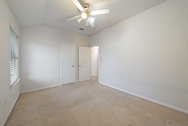 unfurnished bedroom featuring carpet floors, baseboards, visible vents, and lofted ceiling