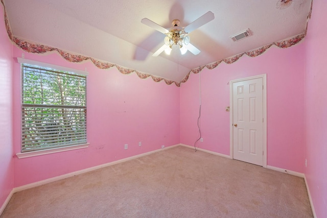 spare room with light colored carpet, a ceiling fan, baseboards, and visible vents