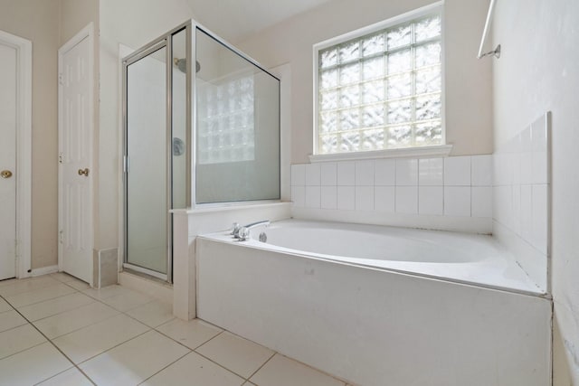 full bathroom with a garden tub, tile patterned flooring, and a shower stall