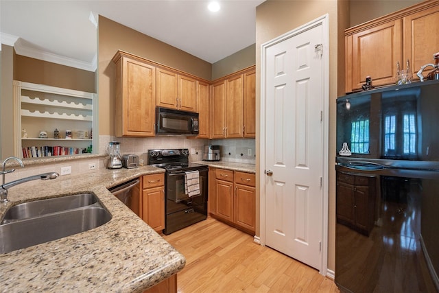 2400 Mccue Rd Unit 260, Houston, TX 77056 - kitchen with black appliances, a sink, light wood-style floors, light stone counters, and ornamental molding