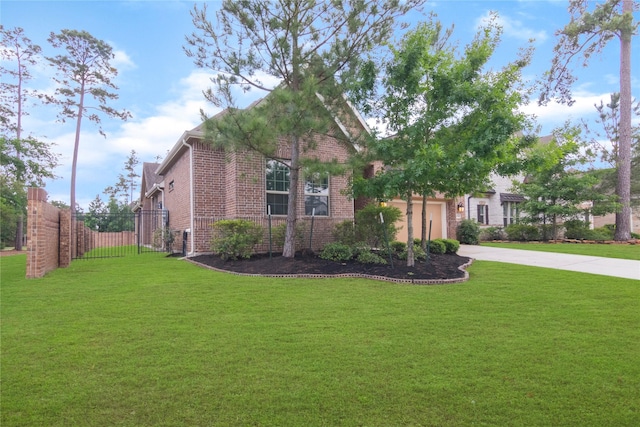 view of front facade featuring fence, a front yard, brick siding, concrete driveway, and an attached garage