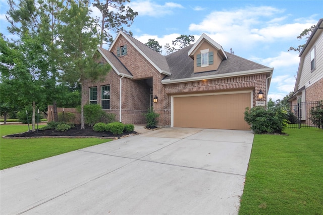 view of front facade featuring a shingled roof, an attached garage, a front lawn, brick siding, and driveway