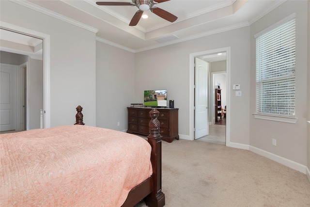 bedroom with light carpet, baseboards, a tray ceiling, visible vents, and ornamental molding