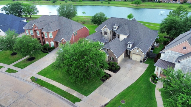 bird's eye view featuring a water view and a residential view