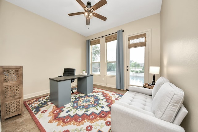 home office featuring a ceiling fan and baseboards