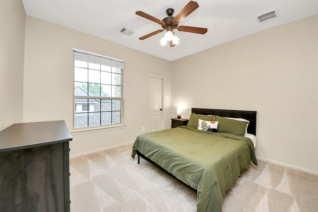 bedroom with visible vents, baseboards, and light colored carpet