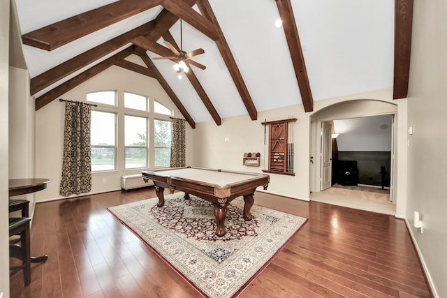 game room featuring arched walkways, beamed ceiling, billiards, and dark wood-type flooring