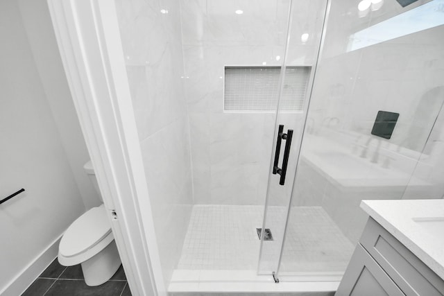 full bath featuring toilet, vanity, a shower stall, and tile patterned floors