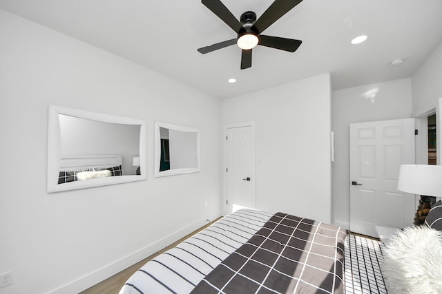 unfurnished bedroom with recessed lighting, a ceiling fan, wood finished floors, and baseboards