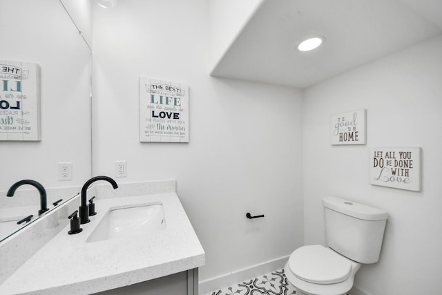bathroom with tile patterned floors, vanity, toilet, and baseboards