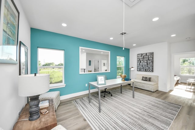 office space with attic access, recessed lighting, visible vents, baseboards, and wood finished floors