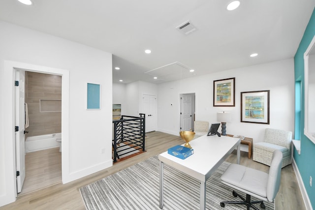 office featuring attic access, light wood-style floors, and baseboards