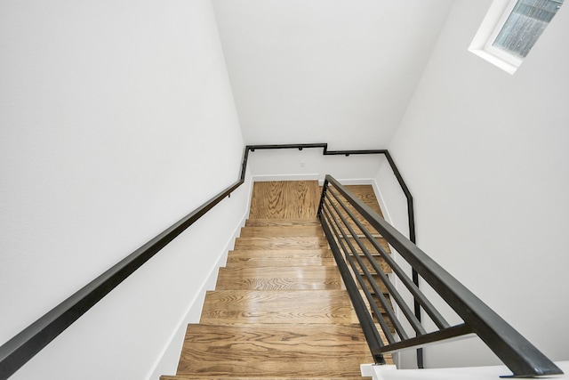 staircase featuring wood finished floors