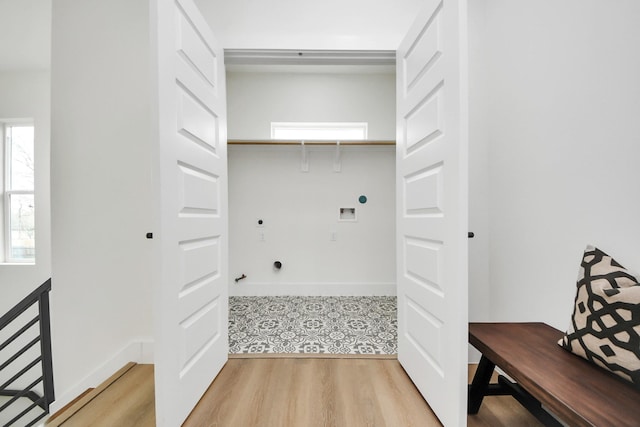 laundry area featuring washer hookup, electric dryer hookup, baseboards, light wood finished floors, and laundry area
