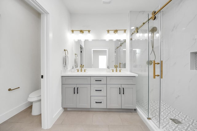 bathroom featuring double vanity, toilet, tile patterned flooring, and a marble finish shower