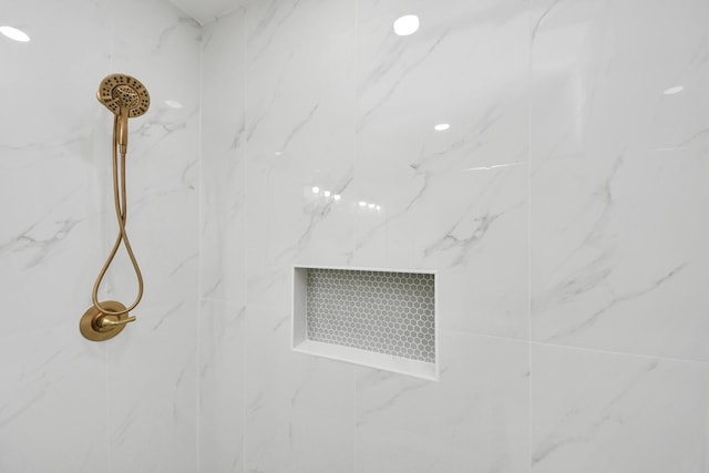 room details featuring a marble finish shower