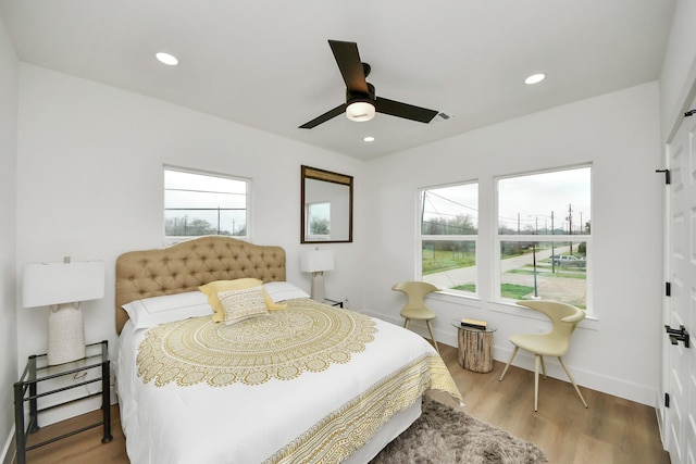 bedroom featuring wood finished floors, recessed lighting, a ceiling fan, and baseboards
