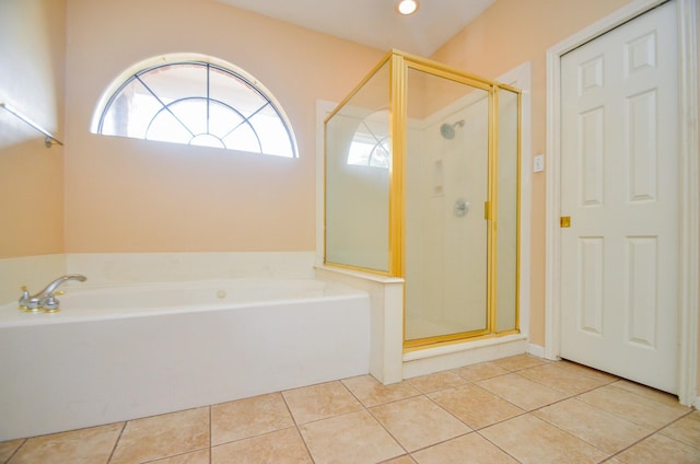 bathroom featuring a garden tub, a stall shower, and tile patterned floors