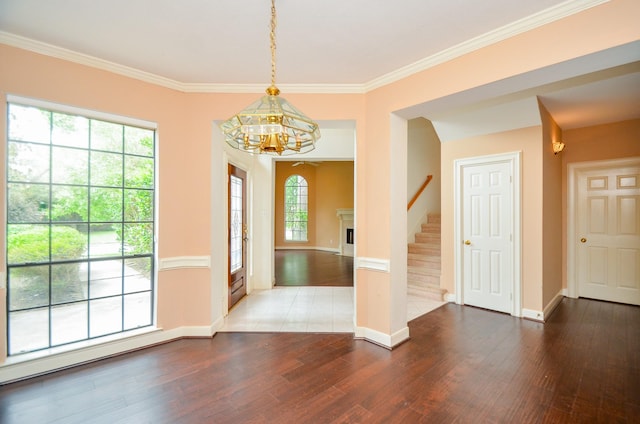 interior space with wood finished floors, a chandelier, and baseboards