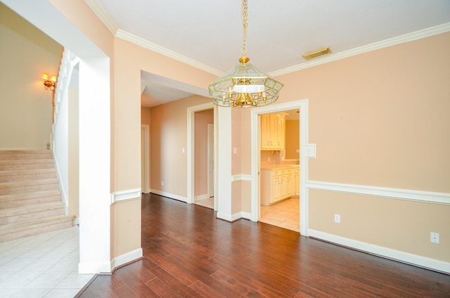 interior space featuring ornamental molding, stairway, visible vents, and a notable chandelier