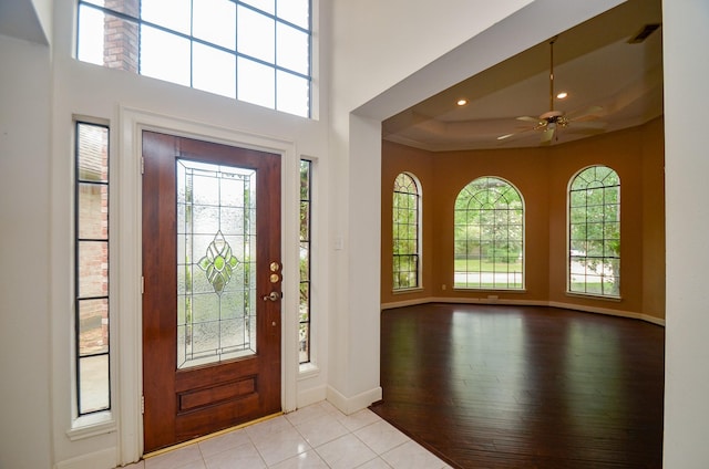 entryway featuring recessed lighting, a high ceiling, light wood-style floors, a ceiling fan, and baseboards