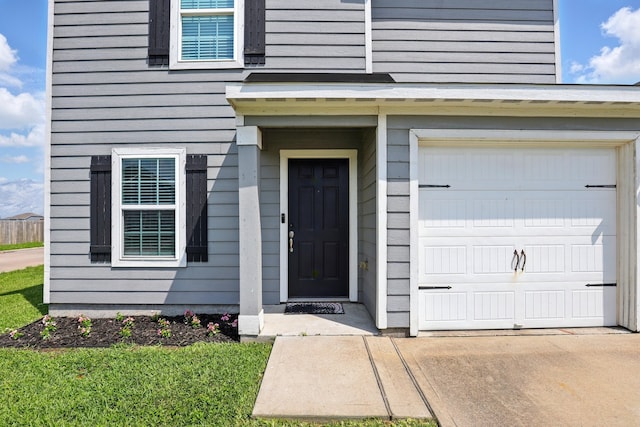 entrance to property featuring an attached garage