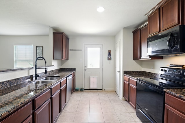 kitchen with dark stone counters, recessed lighting, a sink, light tile patterned floors, and black appliances