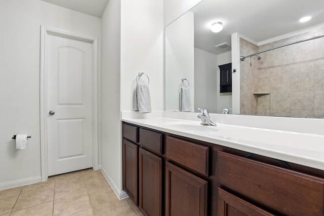 bathroom with visible vents, vanity, tile patterned flooring, and baseboards