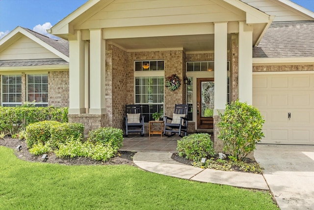 entrance to property with concrete driveway, roof with shingles, covered porch, an attached garage, and brick siding