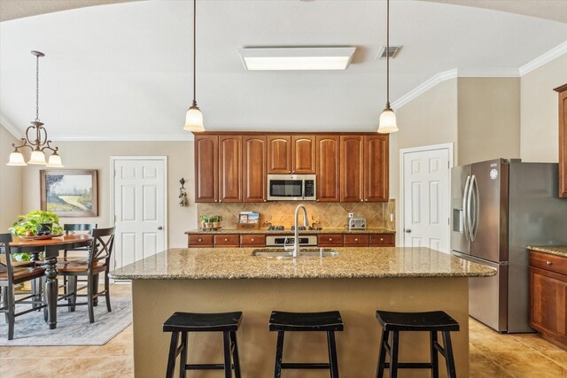 kitchen with crown molding, light stone counters, appliances with stainless steel finishes, and tasteful backsplash