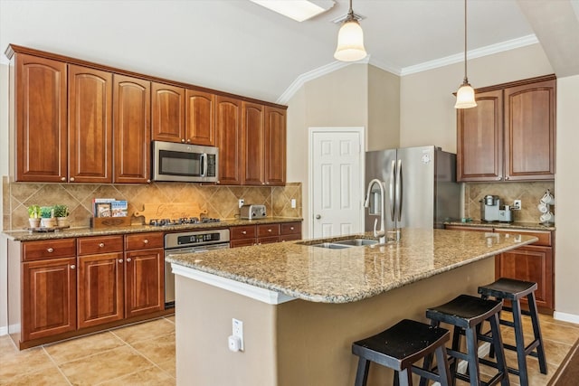 kitchen featuring tasteful backsplash, a sink, stainless steel appliances, light stone countertops, and decorative light fixtures