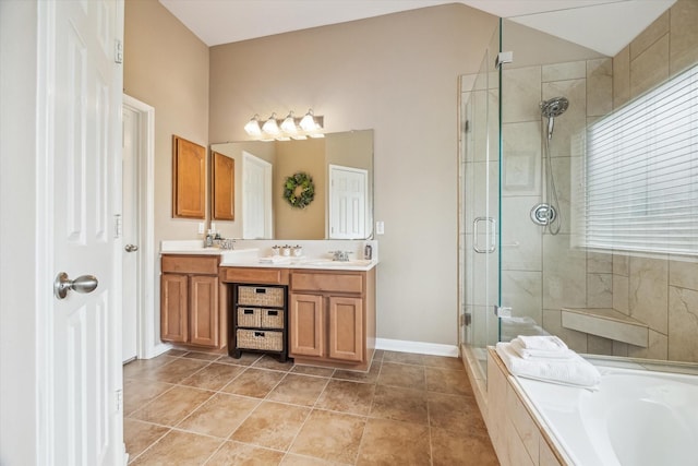 bathroom with a shower stall, a bath, double vanity, baseboards, and lofted ceiling